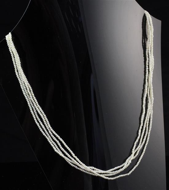 A quadruple strand seed pearl necklace with rose cut diamond set 9ct white gold clasp, 17in.